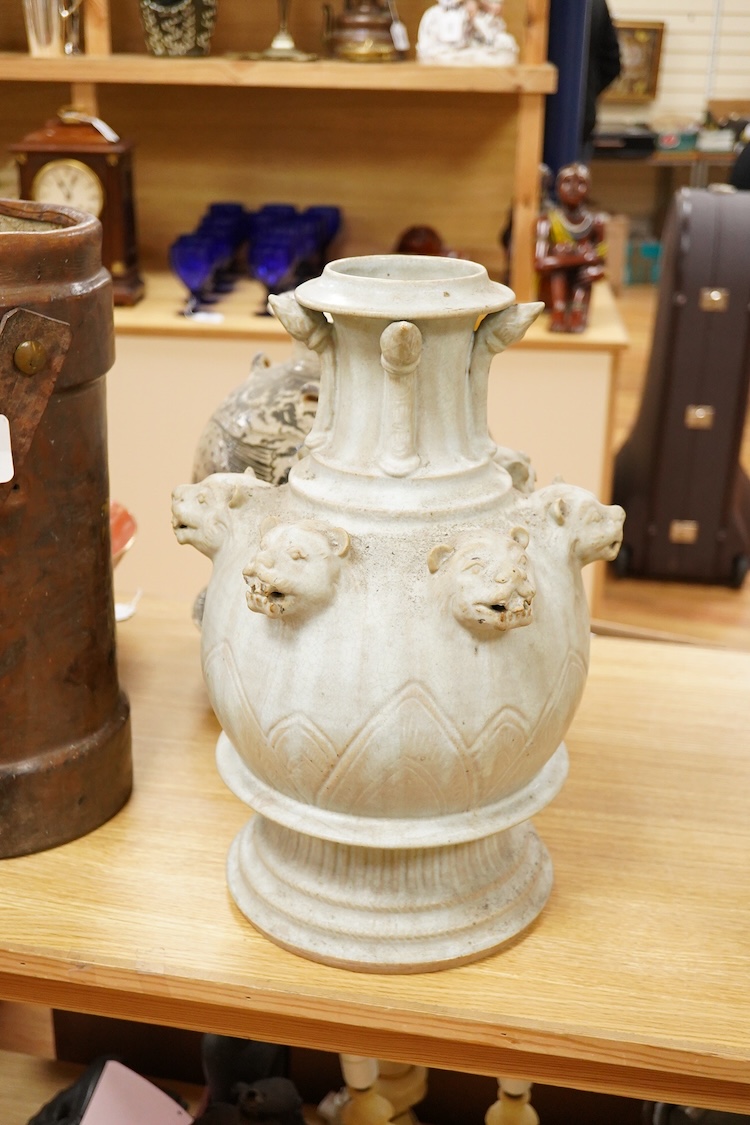 A large Thai pale blue glazed jar decorated with panther masks, 47cm